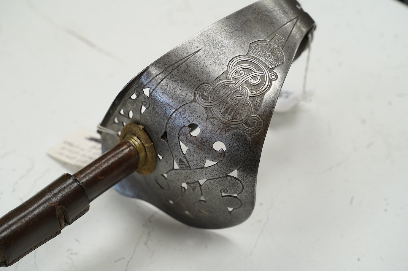 An 1898 pattern British NCO’s sword with leather scabbard, Edward VII cipher to guard, the blade with government stamps, issued 1903, blade 82cm. Condition - fair, some wear overall